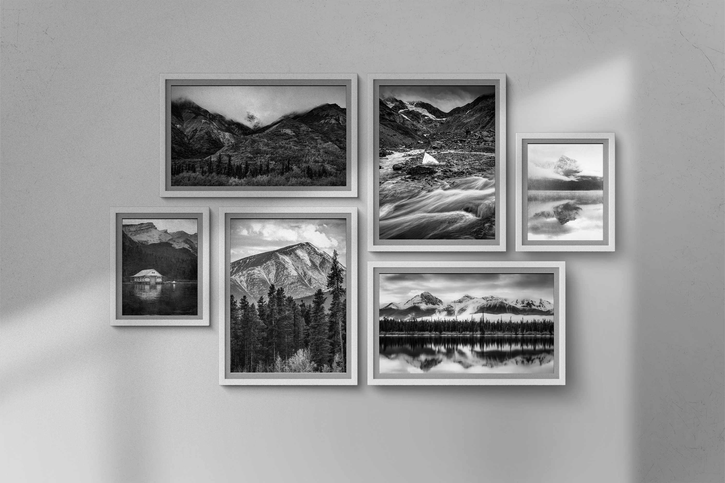 Black and white mountain gallery wall with multiple framed prints by Dan Sproul